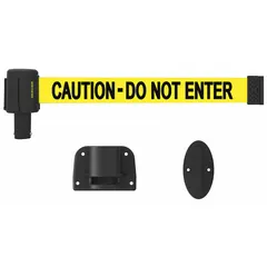 This wall-mount retractable belt barrier features a 15 ft yellow belt with black caution messaging and a black frame. It is used for pedestrian traffic control and area delineation in industrial environments, such as cordoning off hazardous zones or guiding foot traffic.