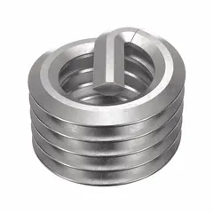 Screw-locking tanged helical insert for thread repair or reinforcement in metal components. Made of 18-8 stainless steel with dry film lubricant finish, fine #10-32 right-hand threads, and tensile strength of 200,000 to 250,000 psi. Requires #10-32 STI tap for installation. Suitable for applications where vibration resistance is needed.