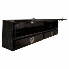 This topside truck box features a single flip-up door with a T-handle and keyed lock, constructed from aluminum with a black finish. It is designed for securing tools and equipment in a pickup bed for industrial, construction, and maintenance applications.