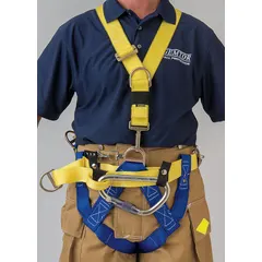 This NFPA Class III full-body harness is constructed from blue nylon webbing with aluminum hardware. It features pass-through buckles on leg and shoulder straps, a back D-ring, and a front D-ring. Designed for fall arrest and rescue applications, it meets NFPA 1893 standards and accommodates waist sizes from 44 to 56 inches.