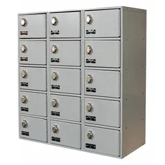 This surface-mount steel locker system is designed for wall-mounting and provides 15 individual compartments across 5 tiers and 3 units wide. It includes number plates for identification and is finished in gray. Typical applications include securing personal electronic devices in schools, offices, and manufacturing facilities to reduce distractions.