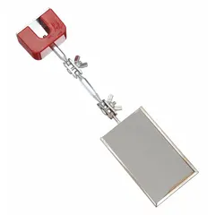 This inspection mirror features a glass mirror with a metal frame and a magnetic mount for hands-free positioning. The mirror measures 3 1/2 inches long by 2 1/8 inches wide. It is used for visual inspection of confined spaces, such as behind machinery or inside equipment, by attaching to metal surfaces.