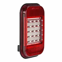 Red rectangular LED backup/reverse light with grommet mount for permanent installation. Complies with SAE J594 standards. Features a PL-3 electrical connector. Overall height 3 3/8 in. Suitable for vehicles and equipment requiring a red warning or illumination light in reverse operation.