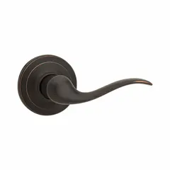 This storeroom lever lockset is designed for interior doors requiring keyed entry from outside and free egress from inside, such as hallways or storage rooms. It features a satin bronze-plated, blackened, satin relieved, clear coated zinc finish and is ADA compliant. The rose style lockset has ANSI function F75 (Hall) and is not ligature-resistant.