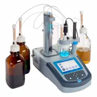Karl Fischer titrator for moisture content analysis using AC/DC imposed current measurement. Features automatic reagent delivery via peristaltic pump, titrant calibration, and user-defined calibration alerts and intervals. Operates on 100 to 240V AC, 50/60 Hz. Includes measurement components AP0014.KF1121; reagents not included