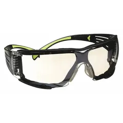 Frameless safety glasses with scratch-resistant gray lens and clear frame. Padded comfort-fit gasket provides a seal around the eyes for protection against airborne particles and impact. Suitable for industrial environments where debris and glare are present.