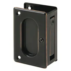 This pocket door pull handle is constructed from brass with a black aged bronze finish. It features a tray/lever style with unthreaded mounting holes. Suitable for use on cabinet doors, drawers, or sliding panels requiring a low-profile pull.