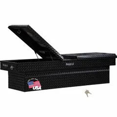 This crossover box features a gull wing lid for side access and is finished in gloss black. With a 71-inch overall width, it is designed for mounting across truck beds to store tools and equipment. Suitable for service vehicles and fleet maintenance applications.