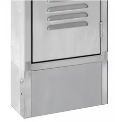 Front base component for standard lockers, made of stainless steel with an unfinished silver finish. Measures 12 in wide, 1/8 in thick, and 6 in deep, with a 12 in footplate width. Includes projecting tabs for secure attachment. Used to provide a stable front foundation in locker installations.