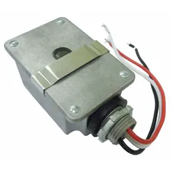 Fixed stem-mounted photocell for automatic dusk-to-dawn lighting control. Features a 1/2 in stem diameter, SPST switching, and operates at 120V AC. Includes a lock nut for secure mounting in outdoor applications such as parking lots, pathways, and building perimeters.