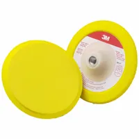 This 7-inch diameter backup pad is made of yellow rubber with a 1/2-inch thickness. It features a hook-and-loop surface for secure disc attachment and a spiral hole pattern to facilitate dust extraction. Designed for use with rotary sanders in applications such as metalworking, woodworking, and automotive finishing