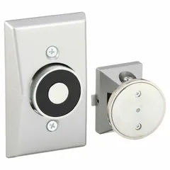 Wall-mounted electromagnetic door holder constructed of aluminum. Fail Safe mode releases the door upon power loss or fire alarm, allowing automatic closure. Used in fire-rated door assemblies for life safety and compartmentation in commercial buildings.