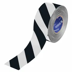 This extra-durable floor marking tape features a black/white striped pattern for cautionary marking of aisles, hazards, and storage zones in industrial facilities. The tape is 3 inches wide by 100 feet long, with a 22 mil thickness and a polyester backing (Series B-553).