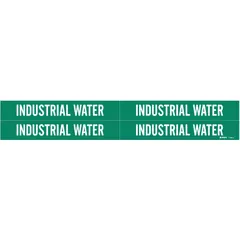 Green adhesive pipe marker with white legend reading 'Industrial Water'. Fits pipe outer diameters from 3/4 to 2-3/8 inches. Each pack contains four markers without arrows. Used to identify industrial water piping in facilities for clear content recognition.