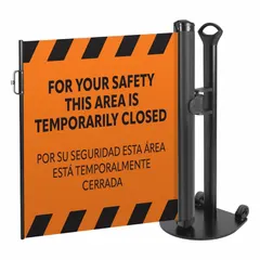 This single-post retractable belt barrier system features a 38-inch post height and an 11 1/2-foot orange belt with a black 'Area Temporarily Closed' message. The belt has a round flat profile and includes a push-through latch. It is used for crowd control and temporary area management in industrial, warehouse, and public settings.