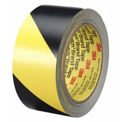3M General Purpose Floor Marking Tape 5702 is a striped black/yellow vinyl tape, 1 in x 108 ft, with a 5.4 mil thickness and no message legend. It is used for marking aisles, hazards, and storage areas in industrial facilities, with the black/yellow striped pattern signaling caution.