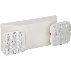 Surface-mount emergency light with adjustable LED lamp heads. White flame-rated plastic housing. Operates on 120/277V AC input; 1 W lamp wattage, 3.6 W emergency wattage. Damp location rated. Complies with UL 924, NFPA 101, NFPA 70-NEC, California Energy Commission Title 20, FCC, and OSHA illumination standards. Suitable for backup illumination in covered walkways, parking garages, and industrial facilities.