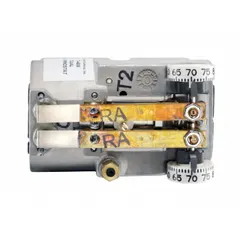 Pneumatic dual-temperature thermostat for day/night operation. Direct-acting: 15 psig during day, 20 psig at night. Temperature control range 55° to 85°F. Two-pipe high-volume air flow output. Vertical mounting; cover not included. Used in commercial HVAC systems for zones requiring separate day and night setpoints.