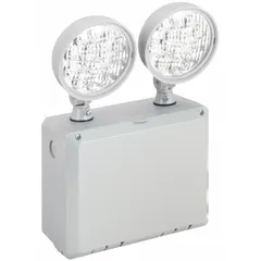 Surface-mounted emergency light with two LED lamp heads. Operates on 120/277V AC input, providing 5.4W emergency output. Gray plastic housing is damp location rated. Suitable for egress illumination in covered walkways, parking garages, and warehouses.