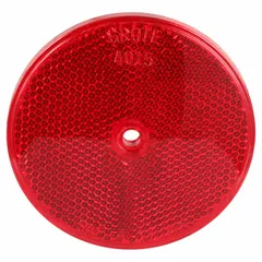 Round red stick-on reflector with acrylic lens, 3 5/16 in overall length and width. Meets SAE A standards for vehicle conspicuity. Commonly applied to trailers, trucks, and equipment to improve visibility and comply with regulatory requirements.