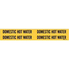 Yellow adhesive pipe marker with black legend reading 'Domestic Hot Water'. Fits pipe outer diameters from 3/4 to 2-3/8 inches. Pack of 4 markers without arrows. Used to identify domestic hot water piping in commercial and industrial facilities.
