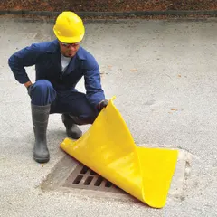 This yellow polyurethane drain cover seal measures 24 x 24 inches with a 1/4-inch thickness. It self-seals over floor drains up to 18 x 18 inches, providing a barrier to help contain spills and prevent debris from entering drains in industrial settings.