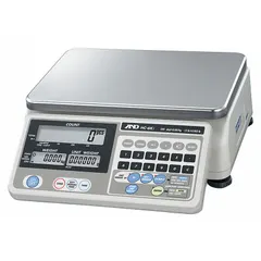 The HC-15KI is a compact bench scale from the HC-I Series with a stainless steel platform measuring 8 1/4 in x 11 3/4 in. It provides a readability of 0.005 lb/0.002 kg and includes an integrated RS-232C interface. This scale is not IP rated and is suited for general industrial weighing tasks such as parts counting or ingredient measurement.