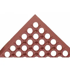 This drainage mat features a raised rings pattern and beveled edge, constructed from red natural rubber with a 1/2 in thickness. It is designed for oil and grease resistance, providing slip resistance and fatigue relief in industrial environments such as machine shops or assembly lines where drainage is needed. The mat is non-reversible.