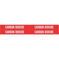 Red adhesive pipe markers with white legend reading 'Carbon Dioxide'. Each set includes 4 markers without arrows, fitting pipe outer diameters from 3/4 to 2-3/8 inches. Used for identifying carbon dioxide lines in industrial piping systems.