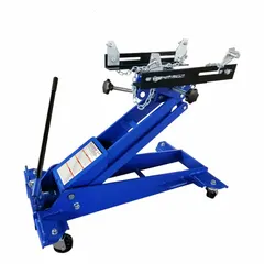 Mechanical transmission jack with 1 ton load capacity, constructed from steel. Operated via manual handle and equipped with a chain securing mechanism for safe lifting and positioning of transmissions during vehicle or equipment service.