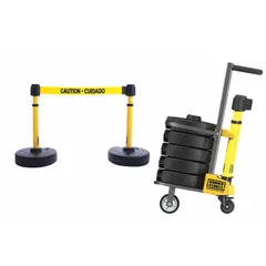 Mobile retractable belt barrier system with two yellow posts and five round flat fillable bases. Features a 15 ft yellow message belt printed with 'Caution - Cuidado'. Used for temporary pedestrian traffic management and cordoning off areas in industrial or public settings.