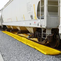 This ENPAC railroad track berm is constructed of PVC and measures 60 ft by 56 in by 4 in, with a spill capacity of 698 gallons. It is designed for placement between rails in rail yards, loading areas, and industrial facilities to contain hazardous liquid spills and prevent environmental contamination.
