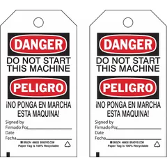 White cotton string tags printed in black, red, and white with bilingual danger message and fields for signature and date. Pack of 100 tags with cotton string fasteners. Used for lockout/tagout procedures on industrial equipment to prevent accidental startup.
