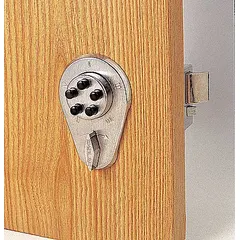 This SIMPLEX mechanical keyless access deadbolt is constructed with a brass finish and includes a deadlocking spring latch. It is designed for doors up to 2 1/8 inches thick, providing keyless entry via push-button combination for interior or exterior applications.