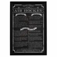 This wood wall art displays air hockey game rules for quick reference in recreational or game-room settings. The black panel measures 12 inches wide and mounts easily on walls near air hockey tables