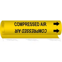 Wrap-around pipe marker with yellow background and black legend reading 'Compressed Air', including directional arrows. Fits pipe outer diameters from 2-1/2 to 7-7/8 inches. Used to identify compressed air lines in industrial piping systems for safety and compliance