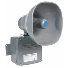 Horn alarm for hazardous locations, suitable for indoor/outdoor use. Operates on 24V AC/DC and produces a horn sound. Gray finish. Typical applications include industrial environments requiring audible signaling in potentially explosive atmospheres.