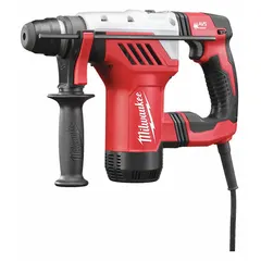 L-shape corded rotary hammer with SDS-Plus chuck, 8 A motor delivering 0-5,500 bpm and 3.6 ft-lb impact energy. Drills up to 1 1/8 in diameter in concrete, masonry, and stone. Suitable for anchor setting and through-hole drilling in construction and maintenance tasks.
