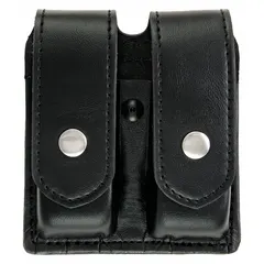 This duty equipment pouch is constructed from black synthetic leather with a plain finish. It measures 5 1/2 inches by 1 3/8 inches and secures with a snap closure. Designed for carrying spare magazines, it is suitable for use by security and tactical personnel.