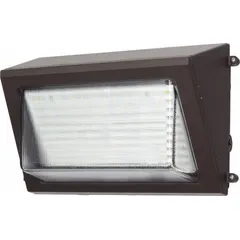 LED full-size wall pack delivering 5600 lumens at 40 watts with selectable 3000K/4000K/5000K color temperatures. Operates on 120 to 277V AC and measures 7 1/2 inches in overall height with a bronze finish. Suitable for outdoor perimeter lighting on commercial and industrial buildings, including entrances, loading docks, and walkways.