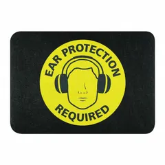 This polypropylene entrance mat measures 24 inches by 17 inches with a 1/8-inch thickness and features an adhesive backing for secure placement on floors. The mat displays a safety message indicating that ear protection is required, suitable for marking areas in industrial or commercial settings where hearing protection is mandatory.